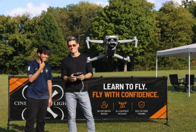Beginner learning to fly a drone outdoors during a hands-on drone lesson in St. Louis.