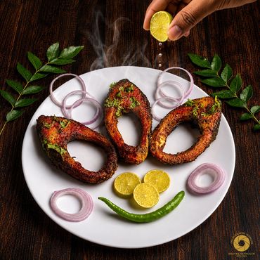 Grilled fish garnished with herbs, onions, lemon, and green chili on a white plate.