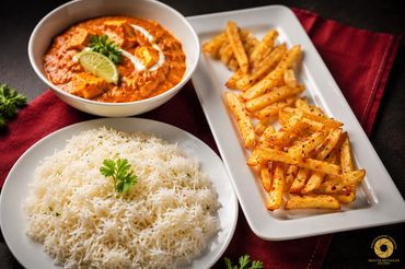 Indian meal with paneer curry, spiced fries, and basmati rice.