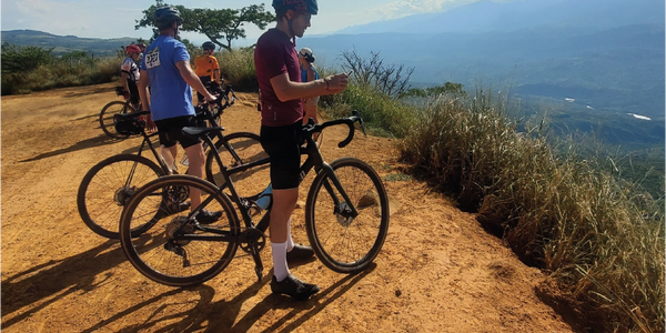 Cyclists taking a break on a scenic mountain trail with bicycles.colombia bike tours