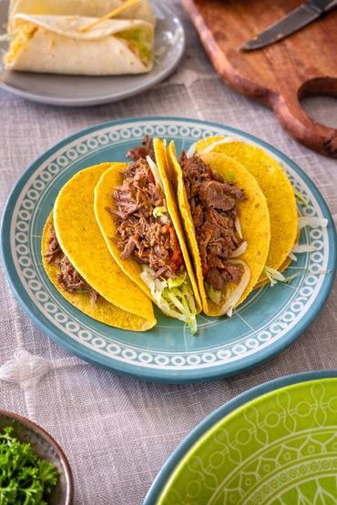 Three beef tacos with lettuce cheese and salsa