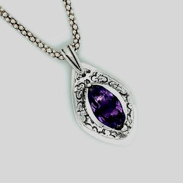 Amethyst cradled in a custom fine silver setting.