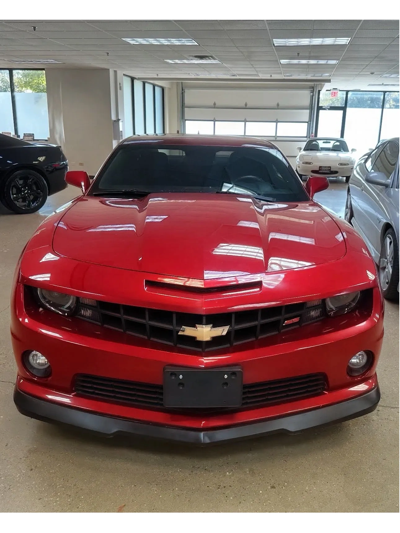 Finished red Chevrolet Camaro inside Starlite Auto Body in Darien, Illinois.