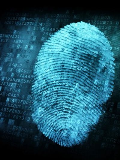 A fingerprint livescan device scanning a hand on a desk.
