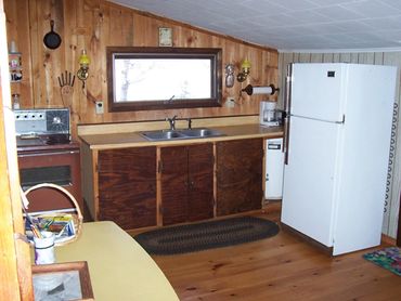 Room with television and refrigerator