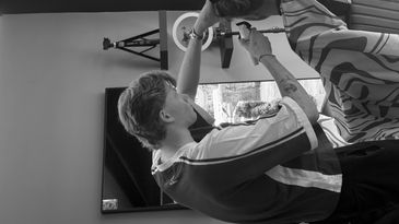 Barber cutting a customer's hair in a barber shop.