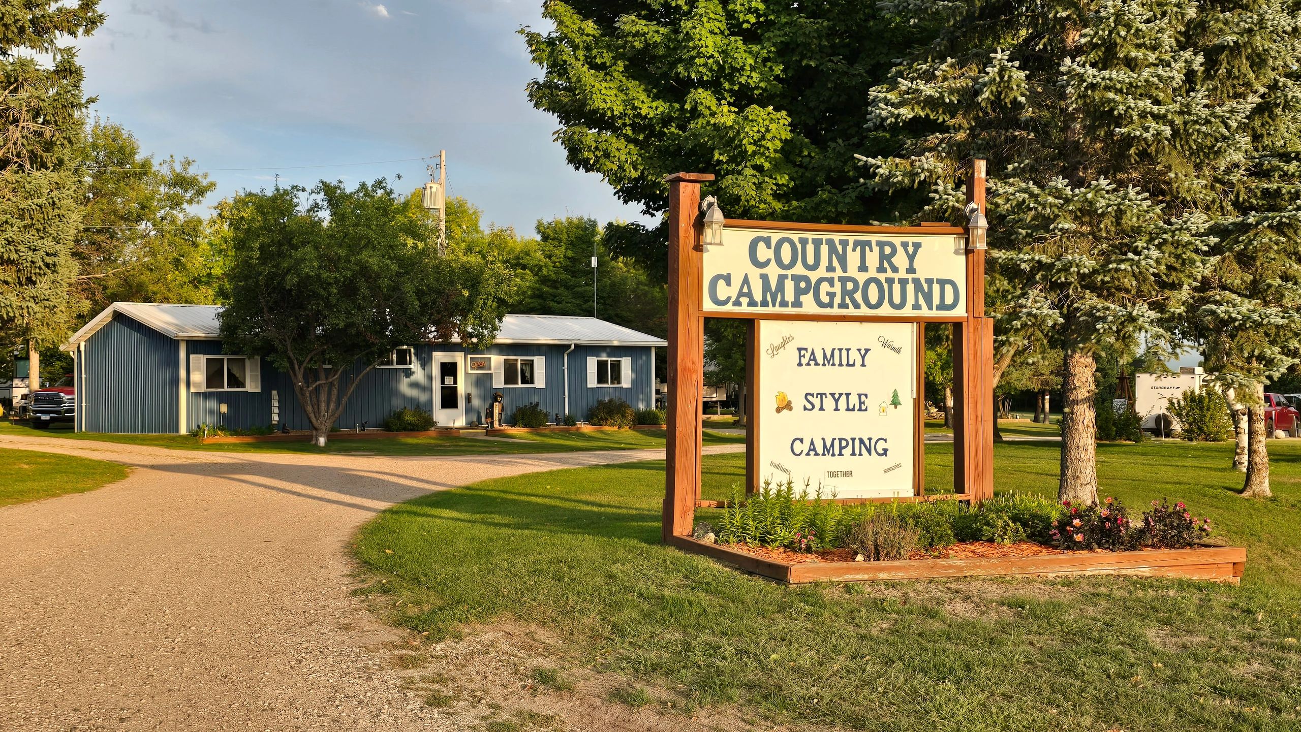 Entrance sign for Country Campground offering family-style camping.