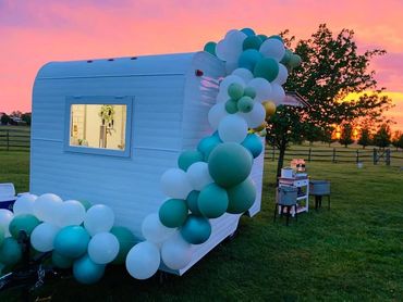 Vintage camper bar, Pearl, with balloon garland at sunset