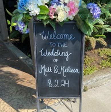 Wedding welcome sign with flowers.