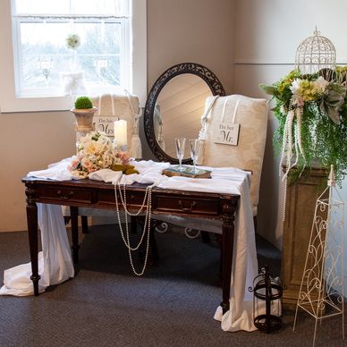 Wedding décor with a table, flowers, and chairs.