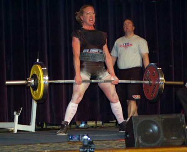 a woman lifting weight and screaming