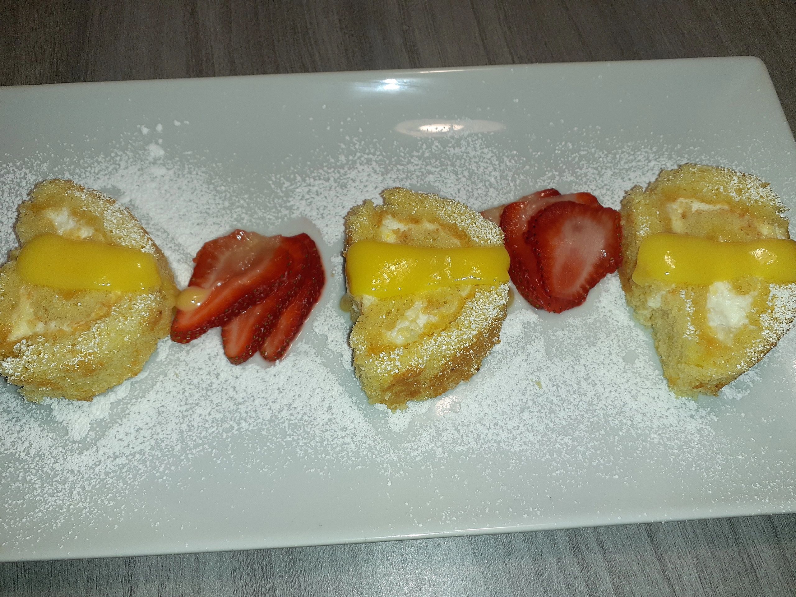 This is a Lemon Swiss Roll! A victorian sponge with lemon curd and whipped cream topped with lemon c