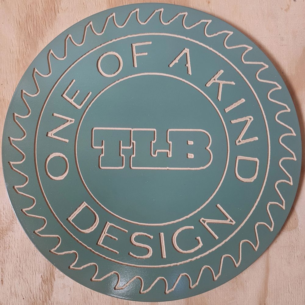 Round teal sign with saw blade edge and text 'One of a Kind Design TLB'.