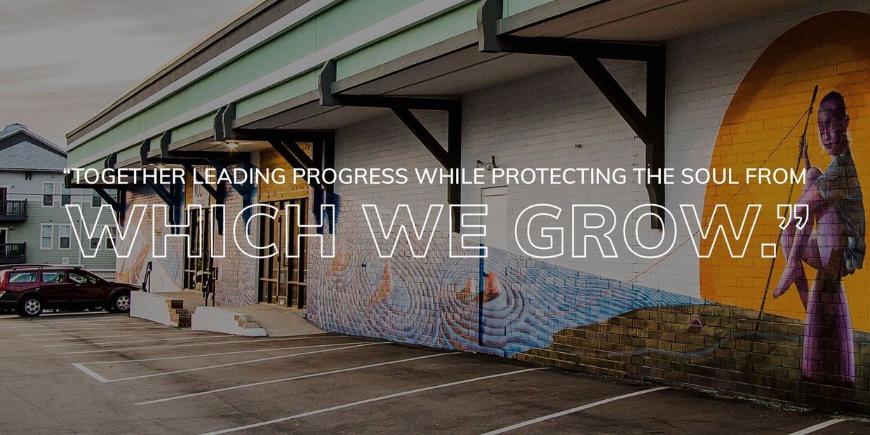 Mural and quote on a building wall about progress and growth protection.