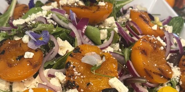 Grilled apricot salad with onions and cheese.
