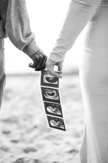 Maternity session, couples hands holding ultrasound photos. Detail photos