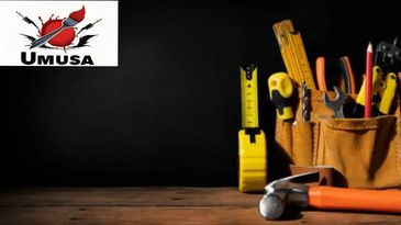 A collection of construction tools arranged on a wooden surface with a black background.