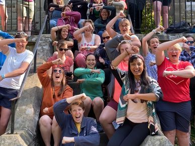 Participants practicing laughter yoga exercises outdoors in Surrey, led by Joyful Outdoors.