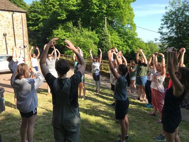 Group of women laughing together during a laughter yoga session in Surrey.
