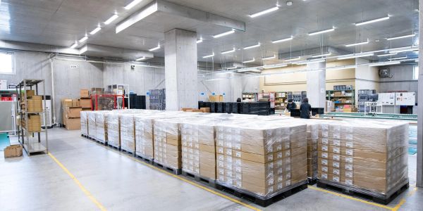 Large warehouse with stacked pallets of boxes.