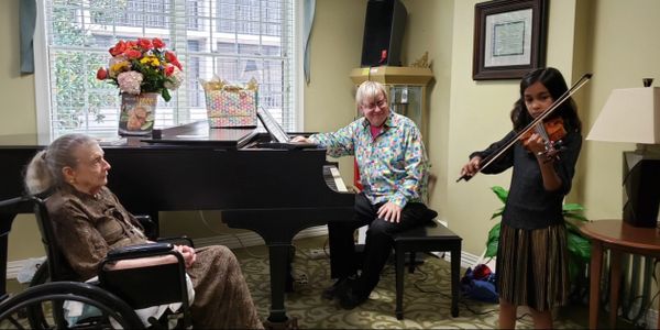 Young musicians playing for the elderly.