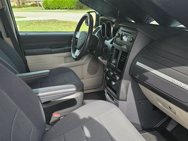 Clean interior of a Dodge vehicle with grey fabric seats and dashboard.