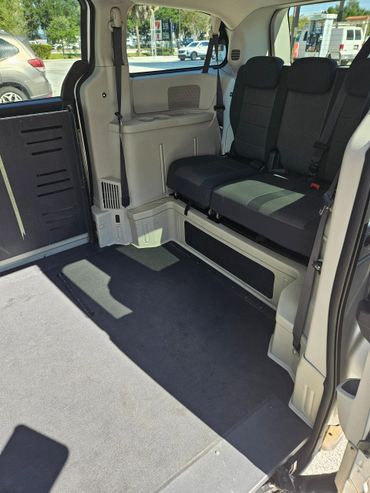 Interior of a van with a wheelchair-accessible ramp and seating.