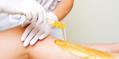 Lady having leg waxed