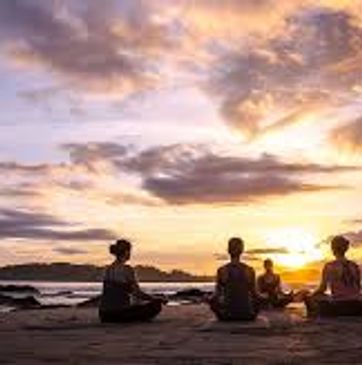 People doing sunset yoga to demonstrate wellness in the antioxidant properties in the NAD iv therapy