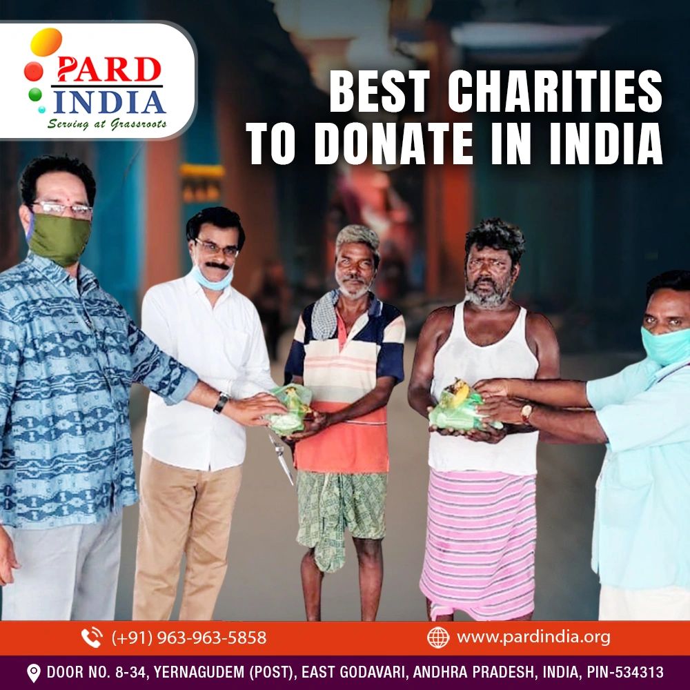Volunteers distributing food to needy men in India as part of charity work.