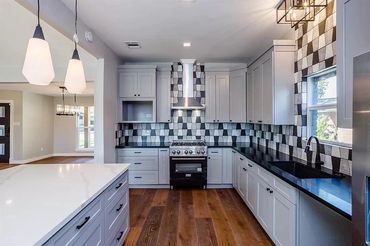 Kitchen, bold backsplash, black and white tile, cabinets, interior design, black countertops
