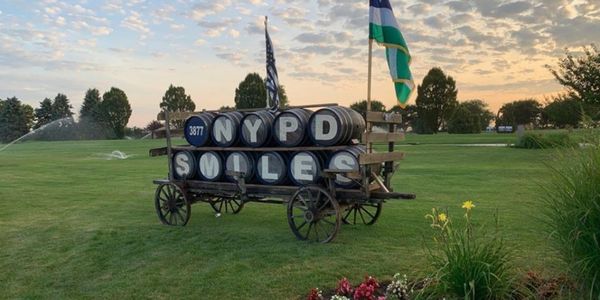 NYPD SMILES barrels in a cart on a field