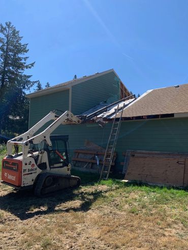 Using telescoping boom to repair roof.