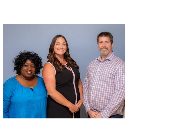 Three people standing next to each other.