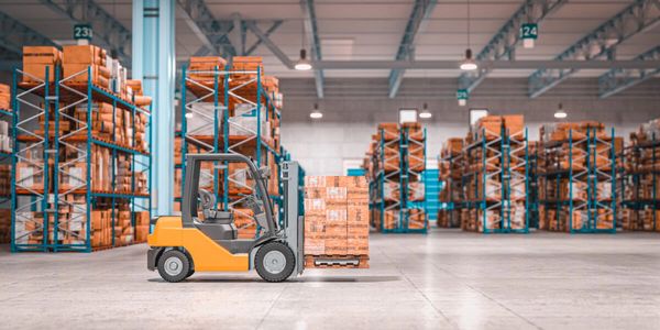 A forklift moving pallets in a large warehouse filled with shelves of boxes.