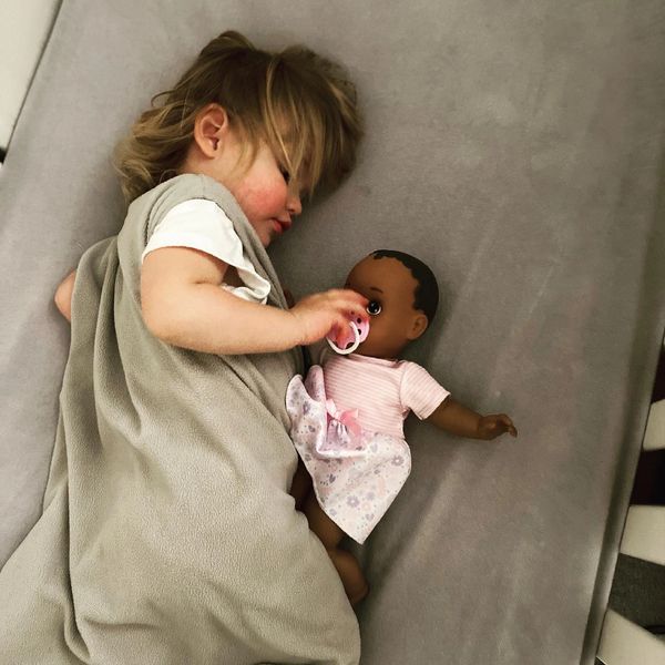 A child playing with a baby doll