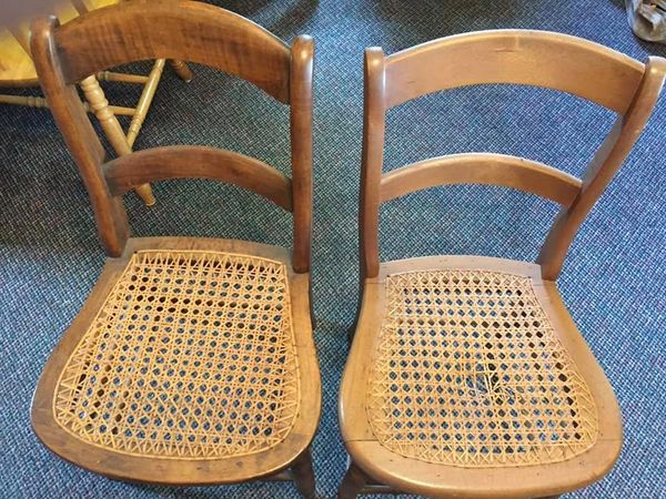 Before photo of two broken wooden chairs.