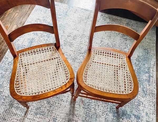 After image of repaired wooden chairs with new caned seats.