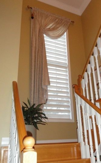 elegant hall drapery  
Hunter Douglas Pirouette shade
tied-back drapery
decorative drapery hardware