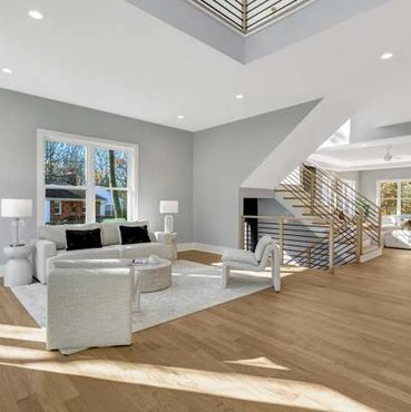 Bright, modern living space with light wood flooring and minimalist furniture.