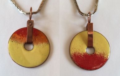 Warm enamel colours orange yellow red on copper donut with copper bail
