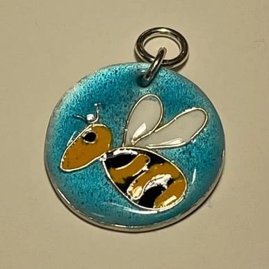 transparent and opaque enamel of a bee on silver pendant