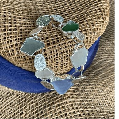 Solid fine and sterming silver bracelet with sea glass as  stones.  Used hand made Reuleaux sliding