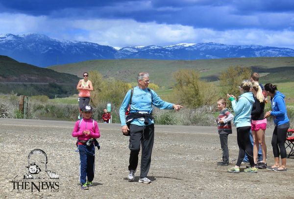 man and child walking, mountains in background, adventure idaho
