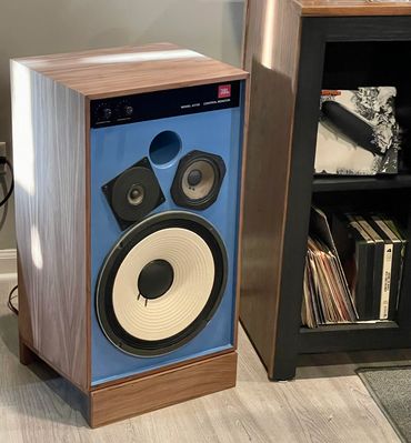 JBL 4311B Completely Restored with Blue Front Baffle on a custom made to fit speaker riser.