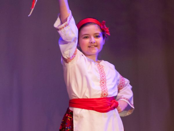 Kyiv School student in performance with tamborine.