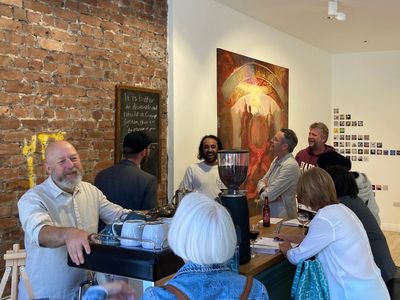 Artists chatting around the coffee machine.