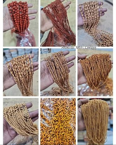 Various strands of prayer beads held in hand, showcasing different bead styles and colors.