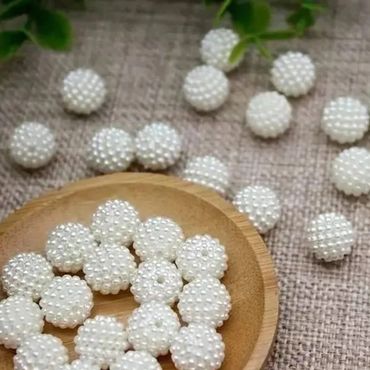 Small round beads decorated with tiny white pearls.