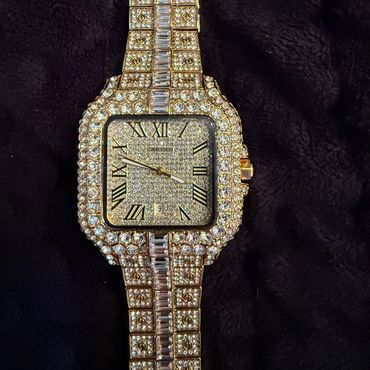 Luxurious Cartier watch encrusted with diamonds and gold accents.